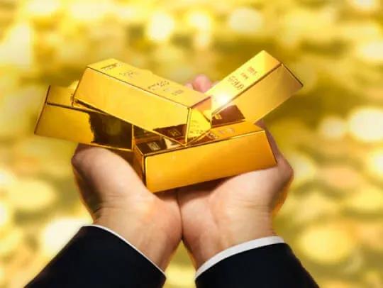 person-holding-gold-bars-stock?io%5Cu003dtransform:fill,width:1000,height:416