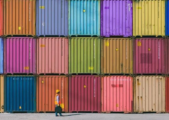 A set of colorful shipping containers stacked on each other. 