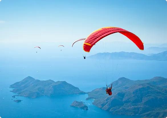 paraglider flying over islands