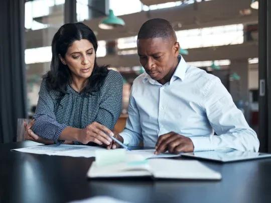 Two people reviewing documents 